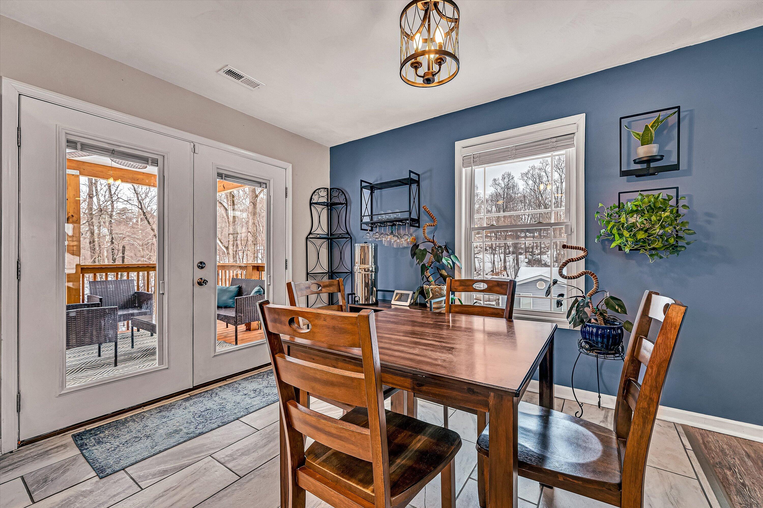 2111 Woodland Road Southeast Roanoke, VA 24014 - Photo 12 of 31 a dining room with furniture a rug a potted plant and a painting