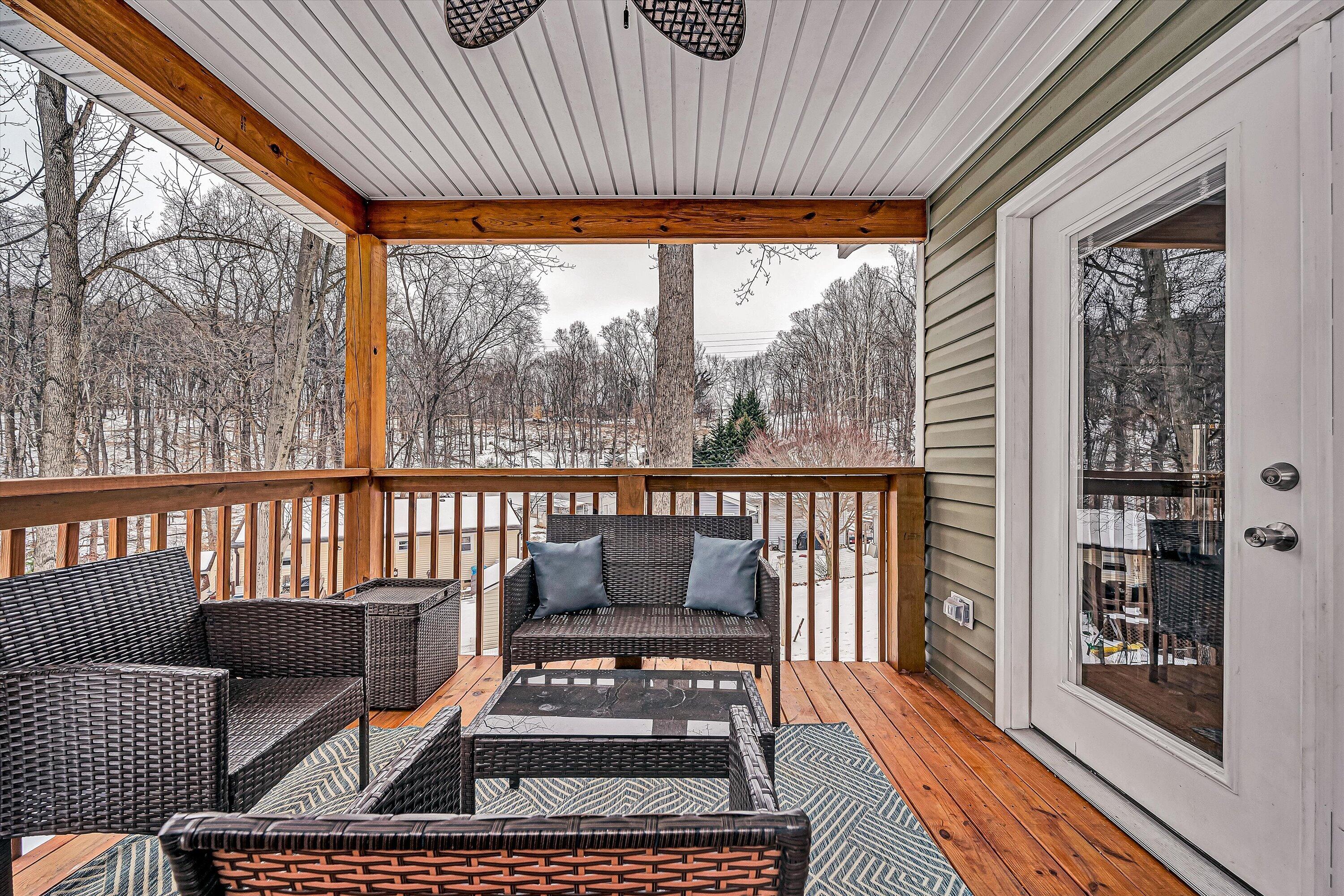 2111 Woodland Road Southeast Roanoke, VA 24014 - Photo 14 of 31 a balcony with wooden floor table and chairs