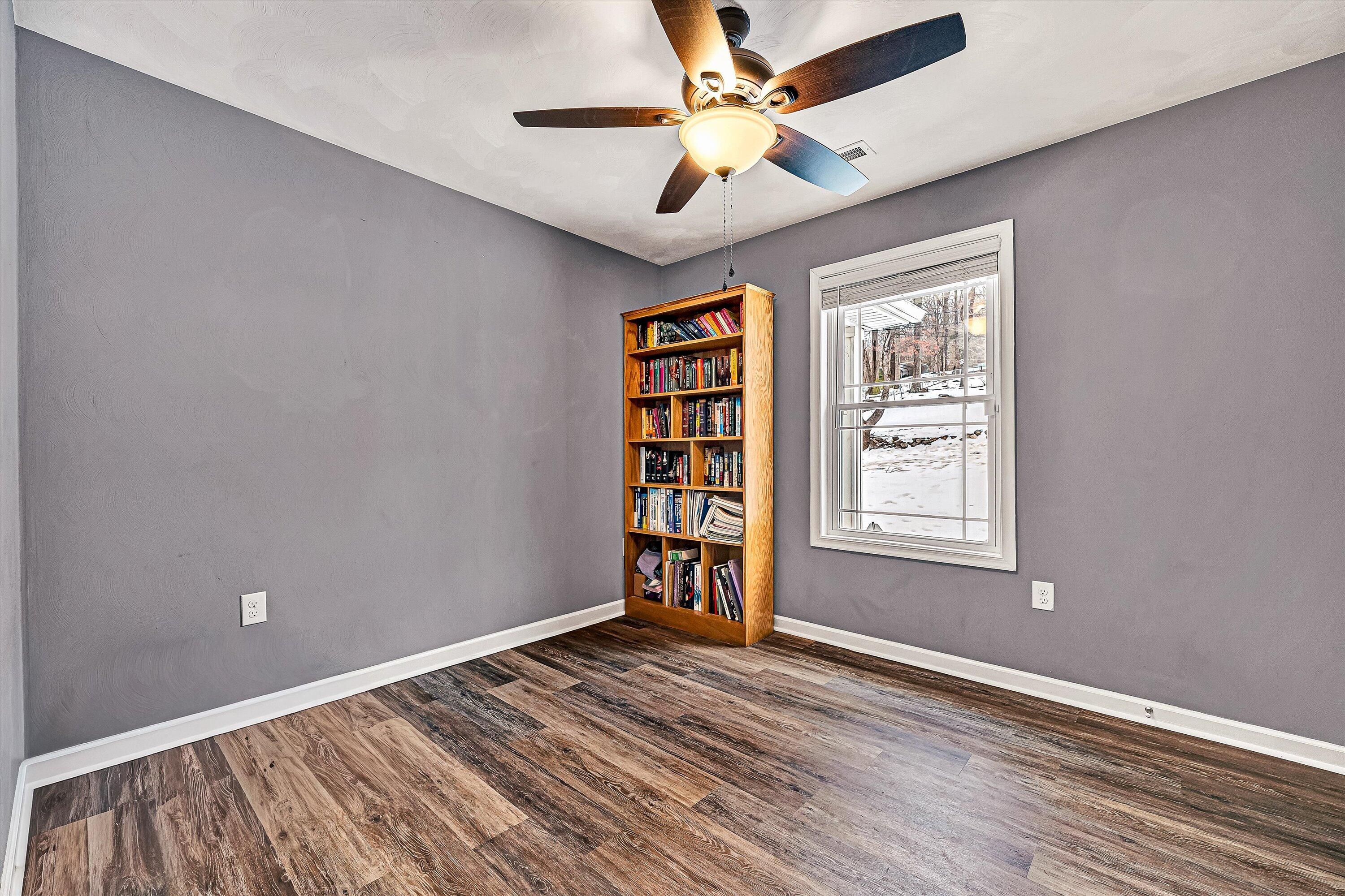 2111 Woodland Road Southeast Roanoke, VA 24014 - Photo 15 of 31 a view of an empty room with a window and wooden floor