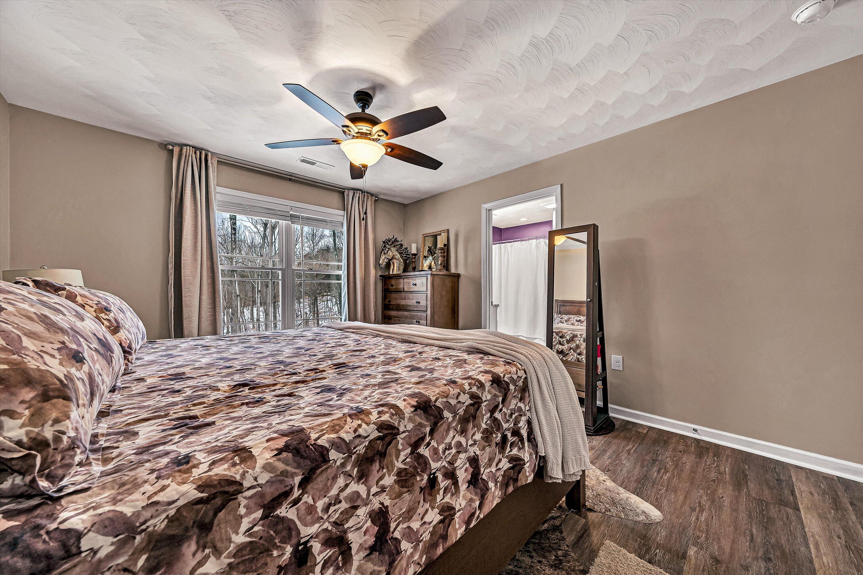 2111 Woodland Road Southeast Roanoke, VA 24014 - Photo 21 of 31 a bedroom with a large bed and a large window