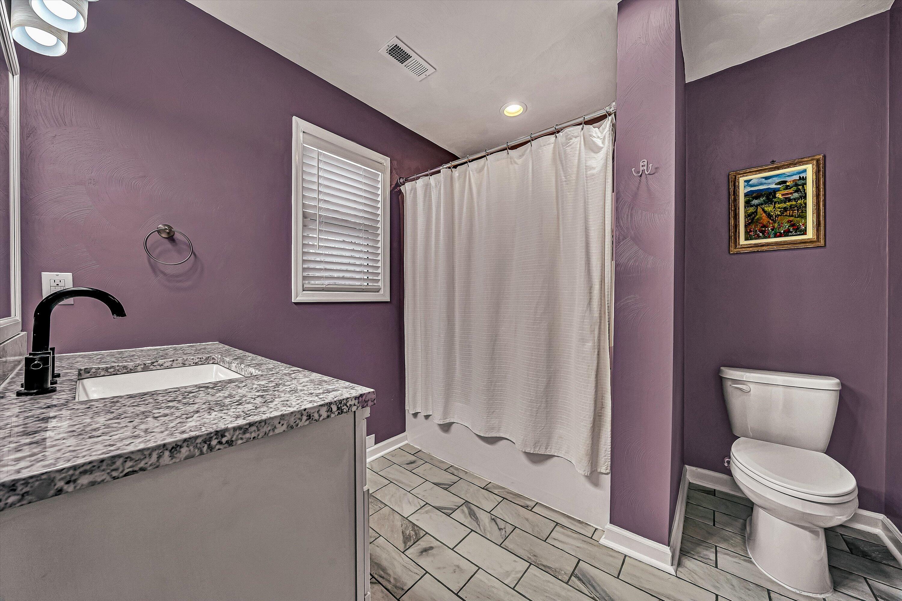 2111 Woodland Road Southeast Roanoke, VA 24014 - Photo 22 of 31 a bathroom with a granite countertop toilet sink and mirror