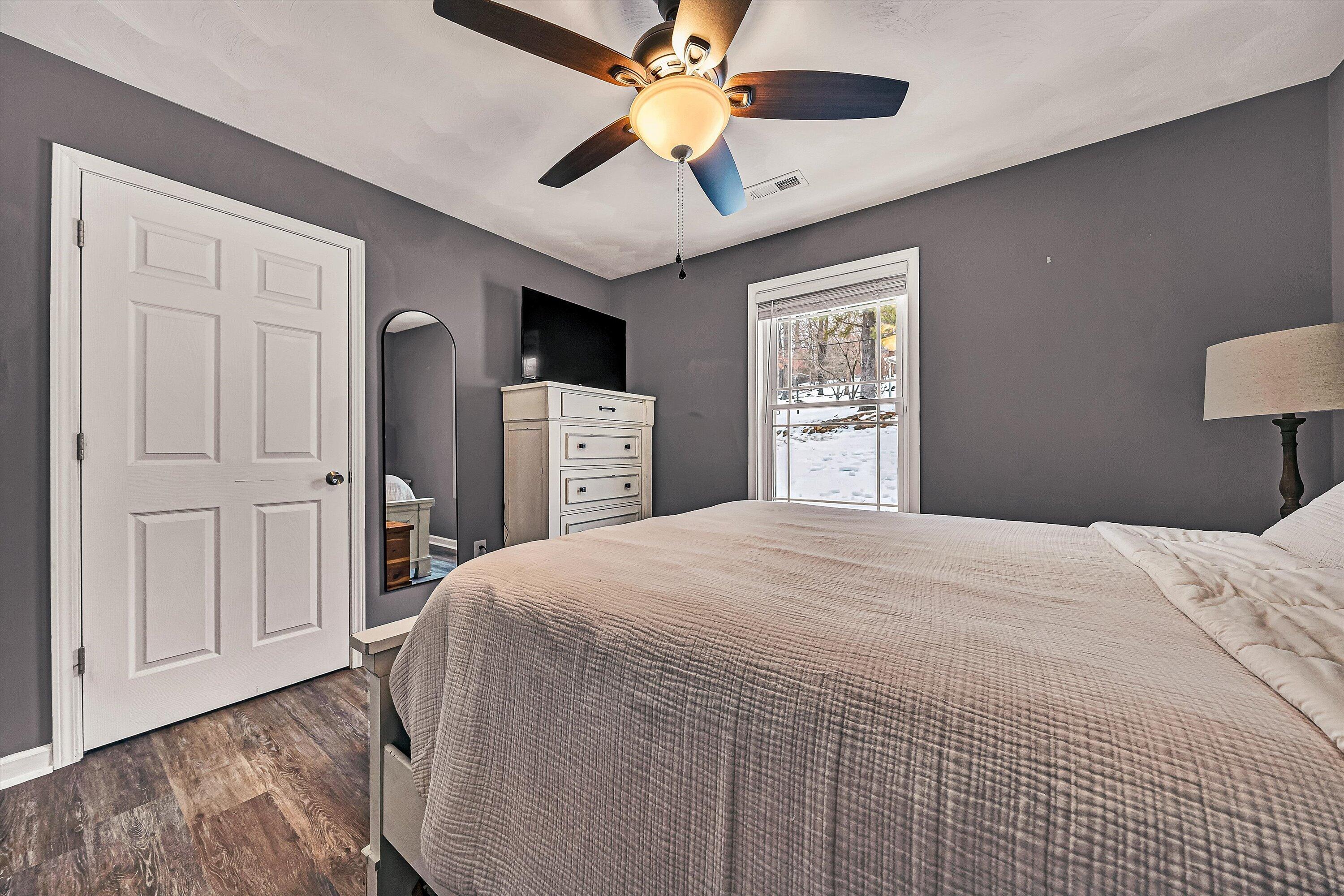 2111 Woodland Road Southeast Roanoke, VA 24014 - Photo 25 of 31 a bedroom with a large bed and a chandelier