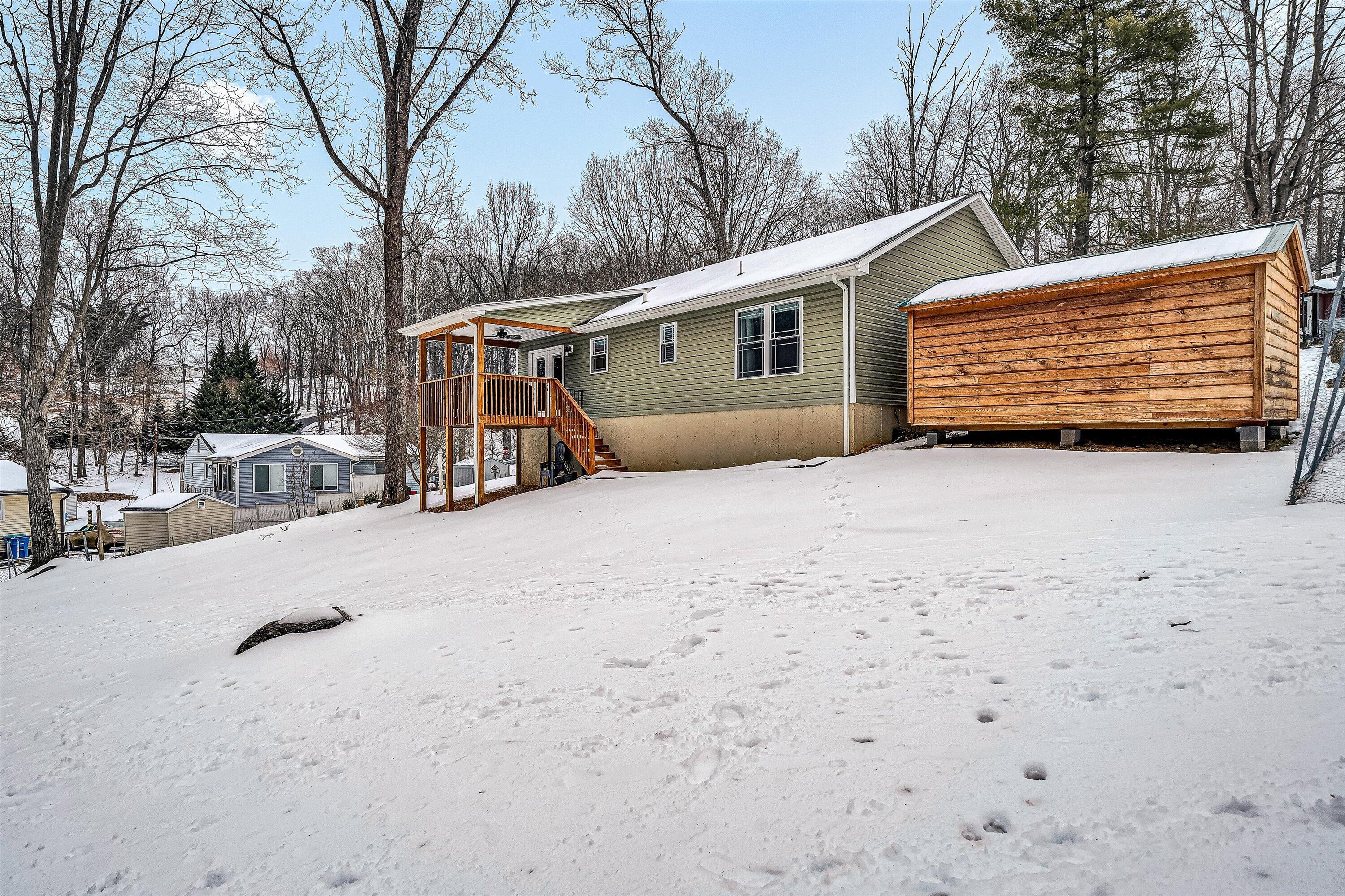 2111 Woodland Road Southeast Roanoke, VA 24014 - Photo 26 of 31 a view of a house with a snow in the yard