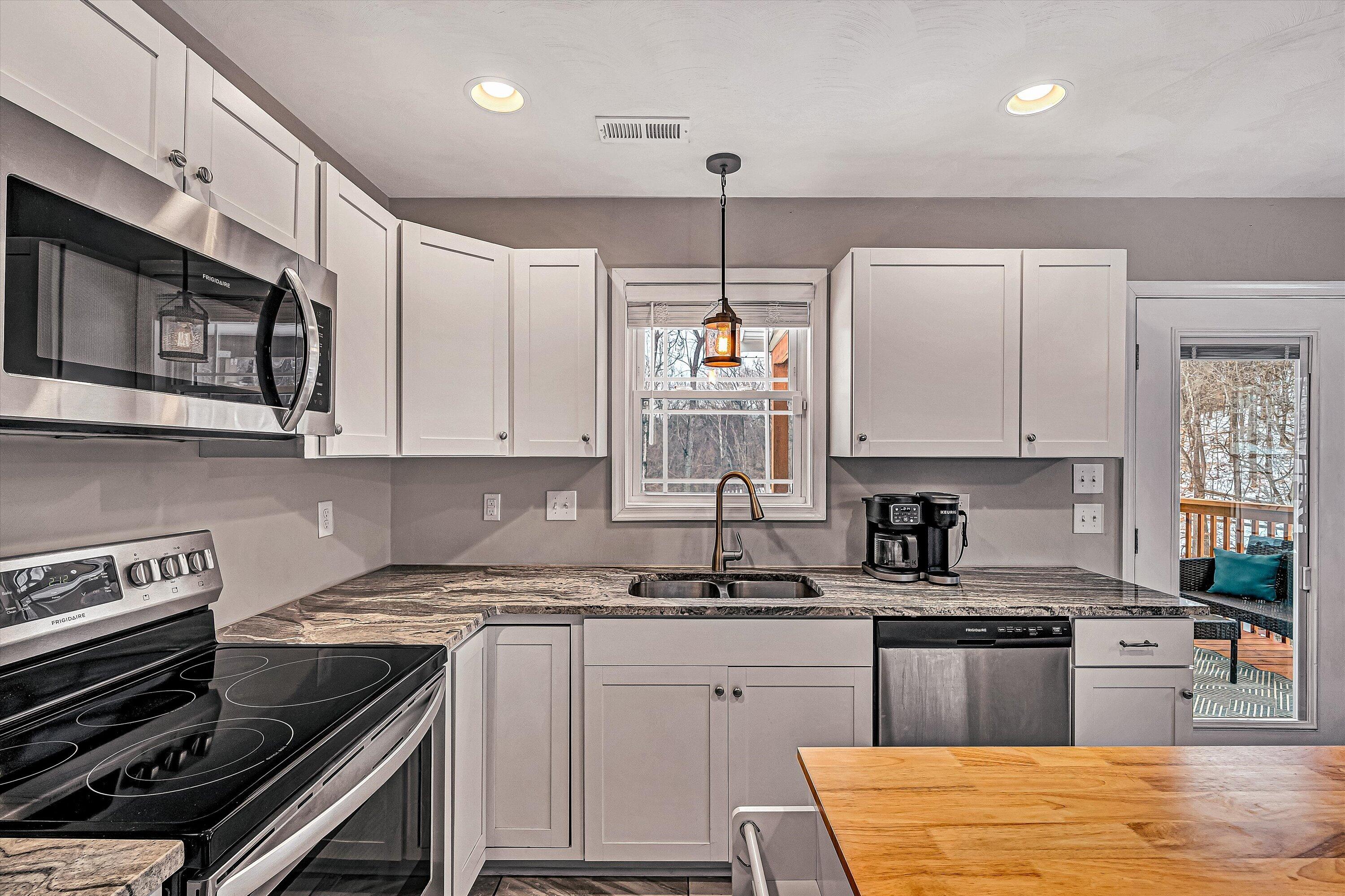 2111 Woodland Road Southeast Roanoke, VA 24014 - Photo 10 of 31 a kitchen with stainless steel appliances granite countertop a stove and a sink