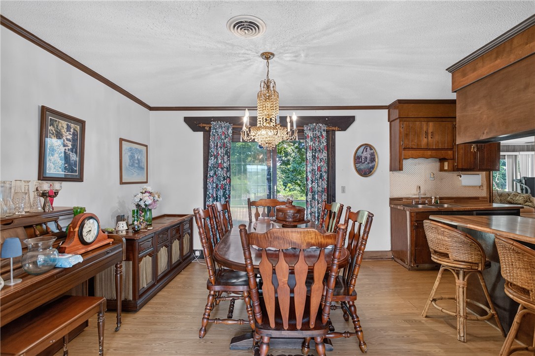 1719 Old Central Road Central, SC 29630 - Photo 26 of 45 Rich wood trim and classic cabinetry frame this inviting dining area and kitchen space.