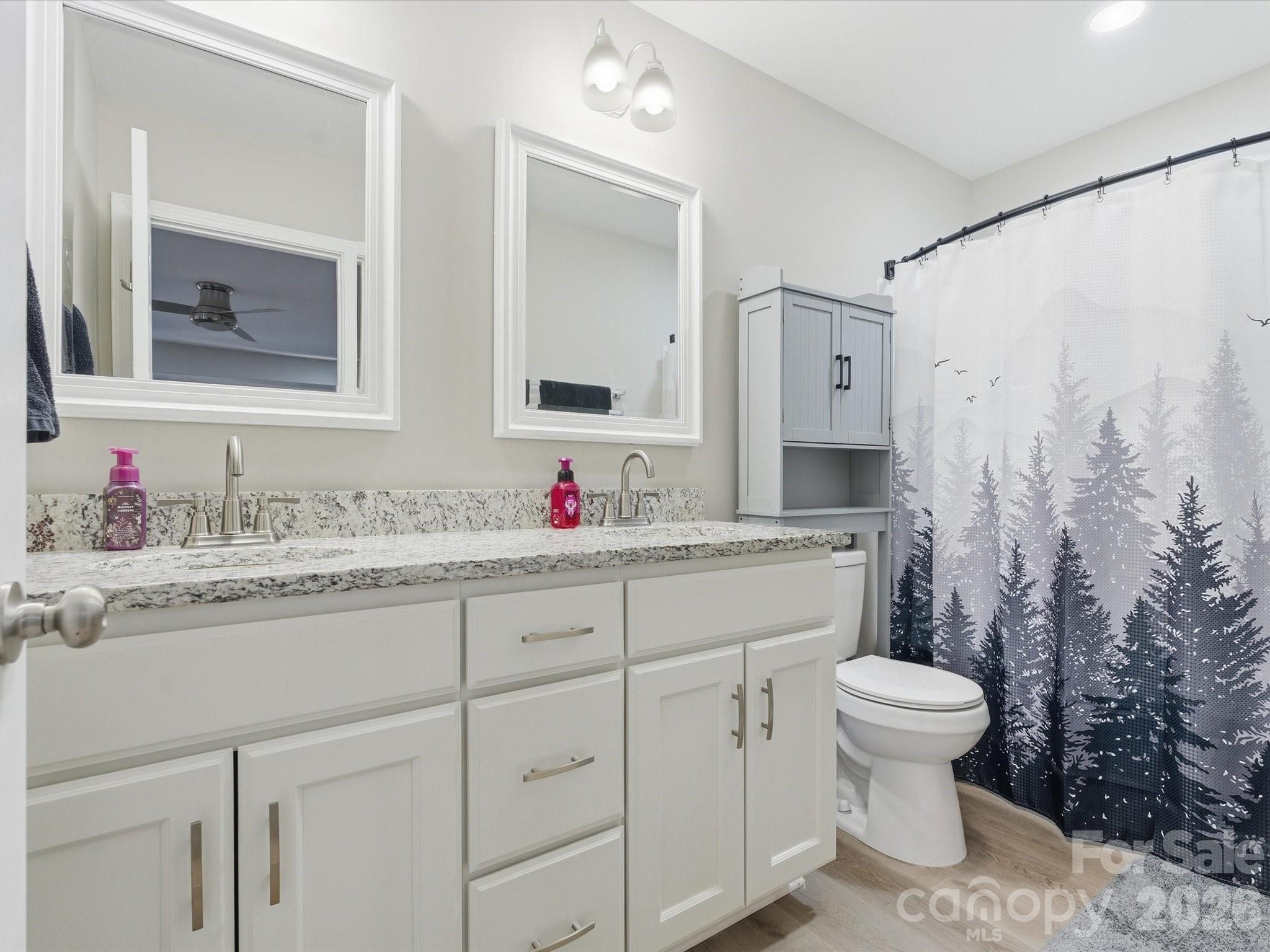 1804 Highway 161, Unit 1 Clover, SC 29710 - Photo 26 of 46 a bathroom with a granite countertop sink mirror vanity and toilet