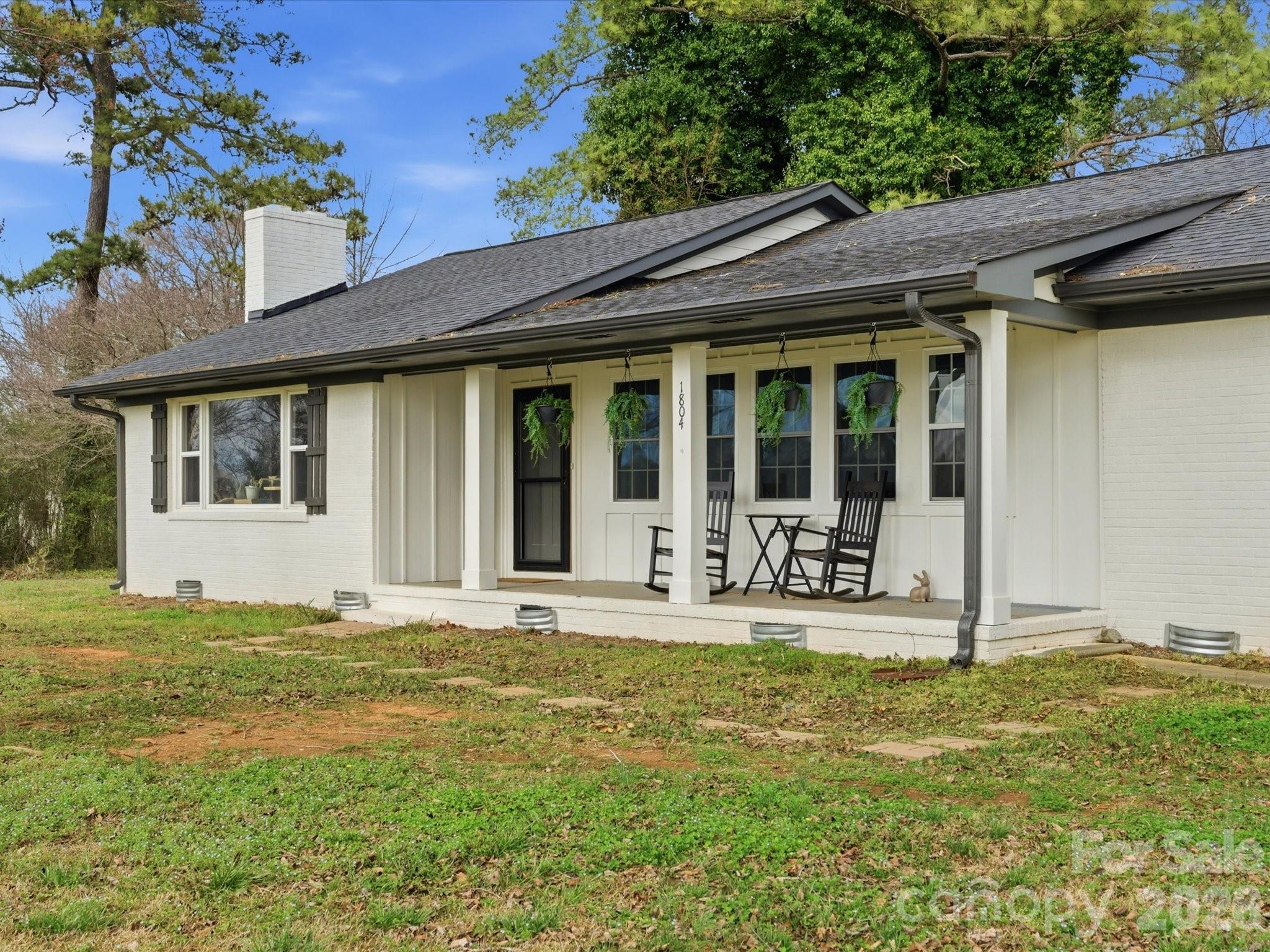 1804 Highway 161, Unit 1 Clover, SC 29710 - Photo 3 of 46 a front view of a house with sitting area and garden