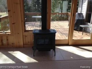 5543 King Road Howell, MI 48843 - Photo 15 of 30 Natural gas fireplace in Florida room