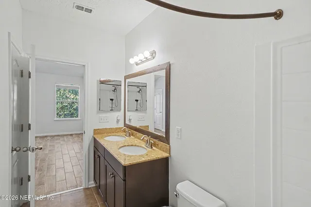 a bathroom with a sink vanity and a mirror