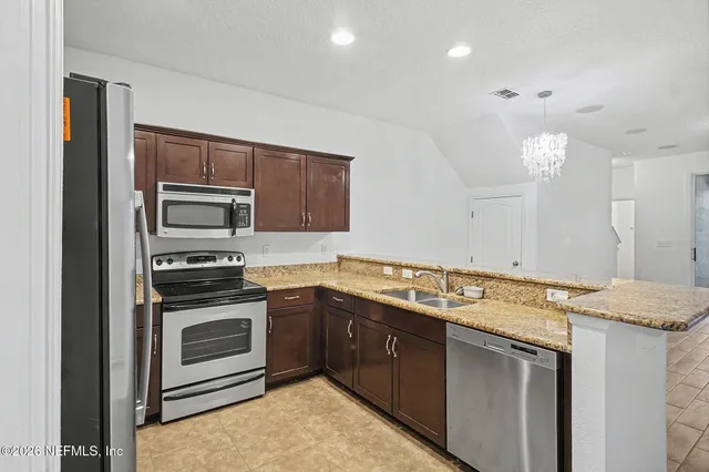 a kitchen with a sink stove and microwave
