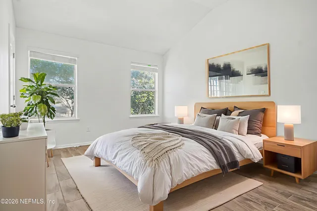 a bedroom with bed and a potted plant