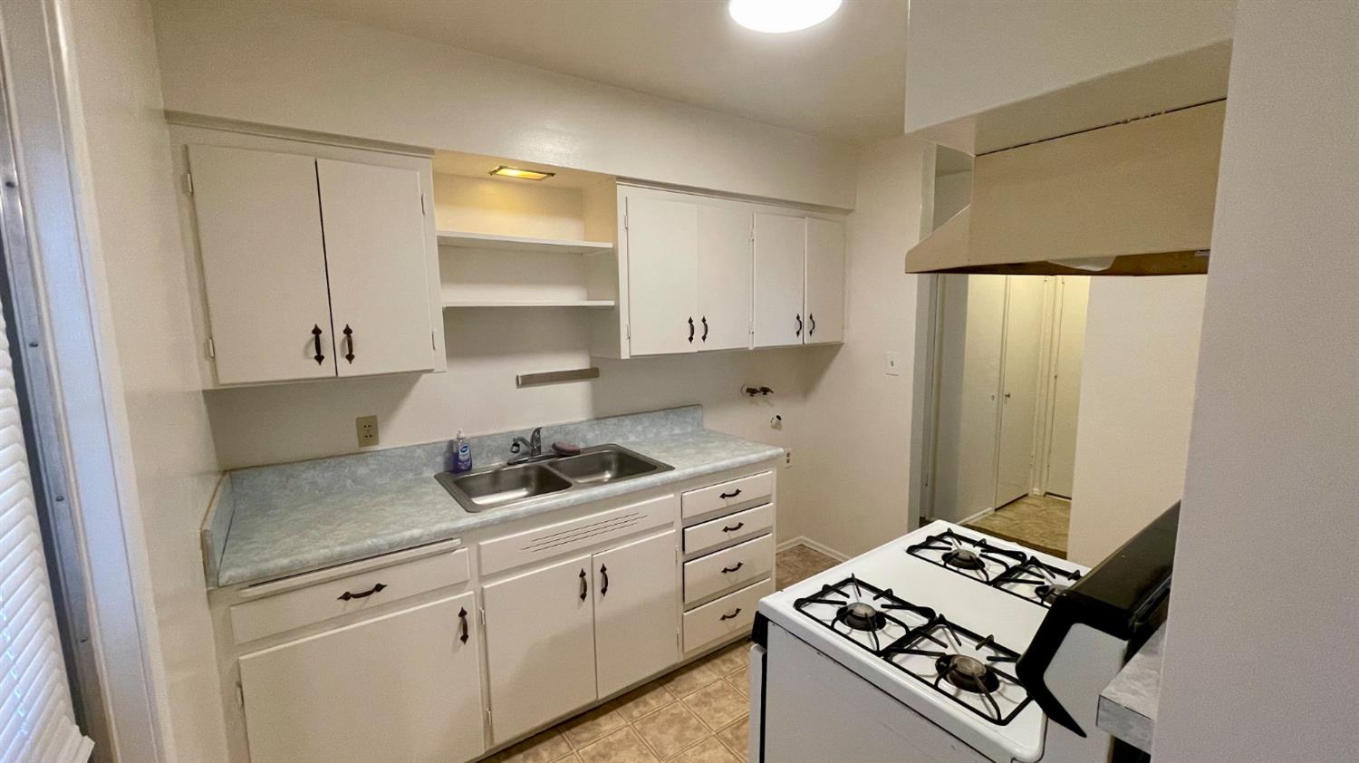 1412 Rodgers Road Hanford, CA 93230 - Photo 5 of 9 a kitchen with a stove and a refrigerator