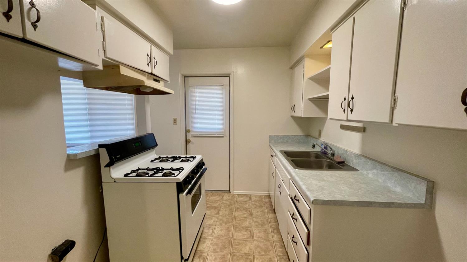 1412 Rodgers Road Hanford, CA 93230 - Photo 6 of 9 a kitchen with granite countertop a sink a stove and refrigerator