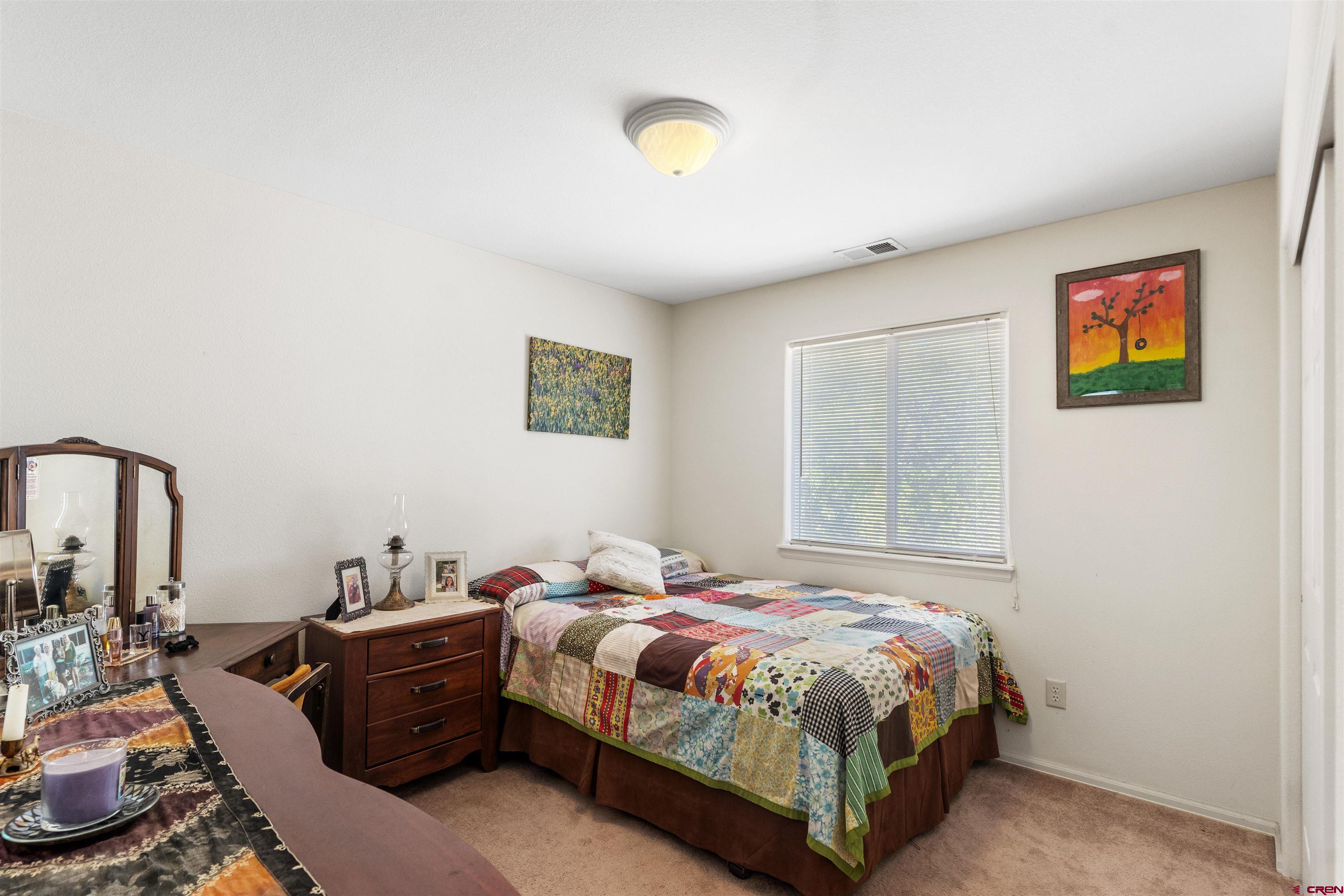 505 20th Street Delta, CO 81416 - Photo 14 of 22 a bed room with a bed and a chandelier