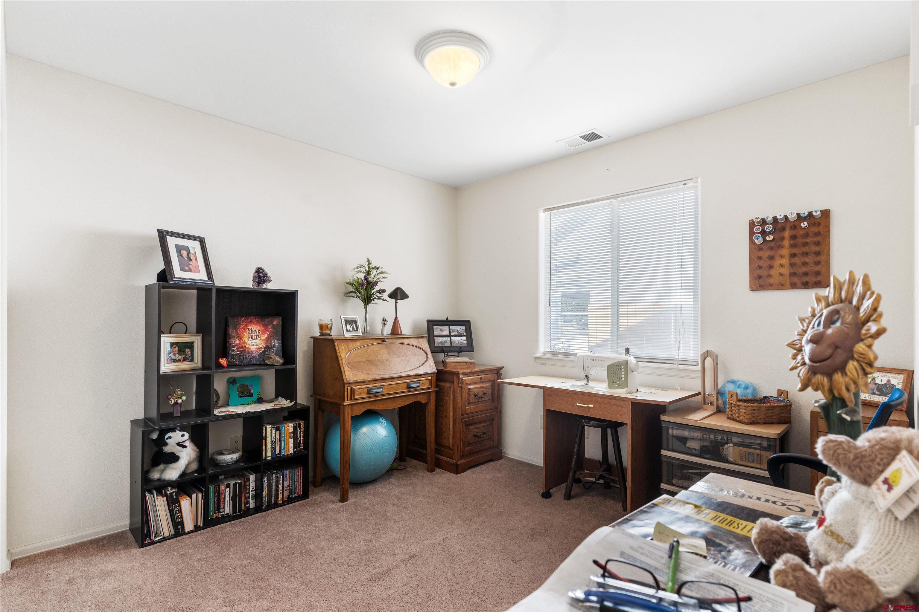 505 20th Street Delta, CO 81416 - Photo 15 of 22 a room with furniture a rug toys and a window