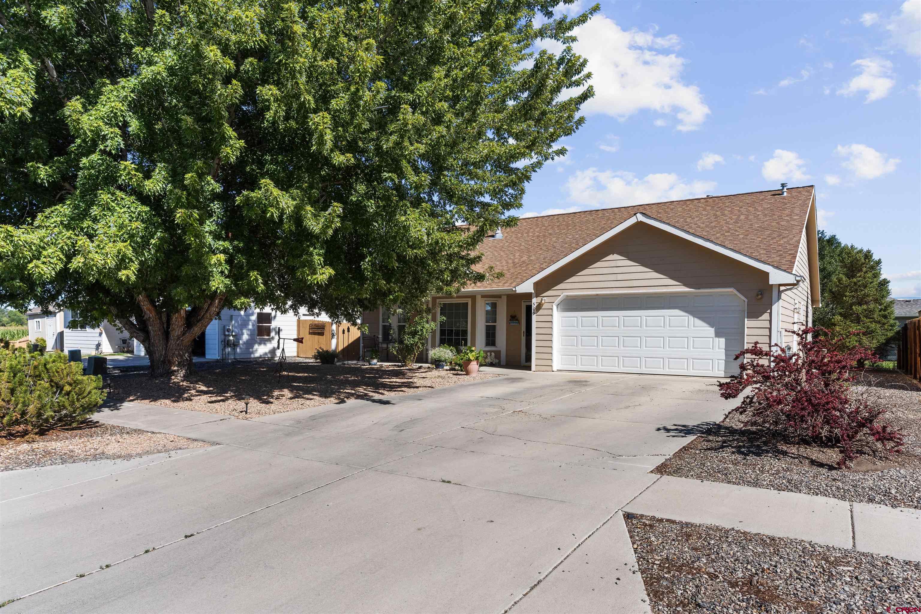 505 20th Street Delta, CO 81416 - Photo 2 of 22 a front view of a house with a yard and garage