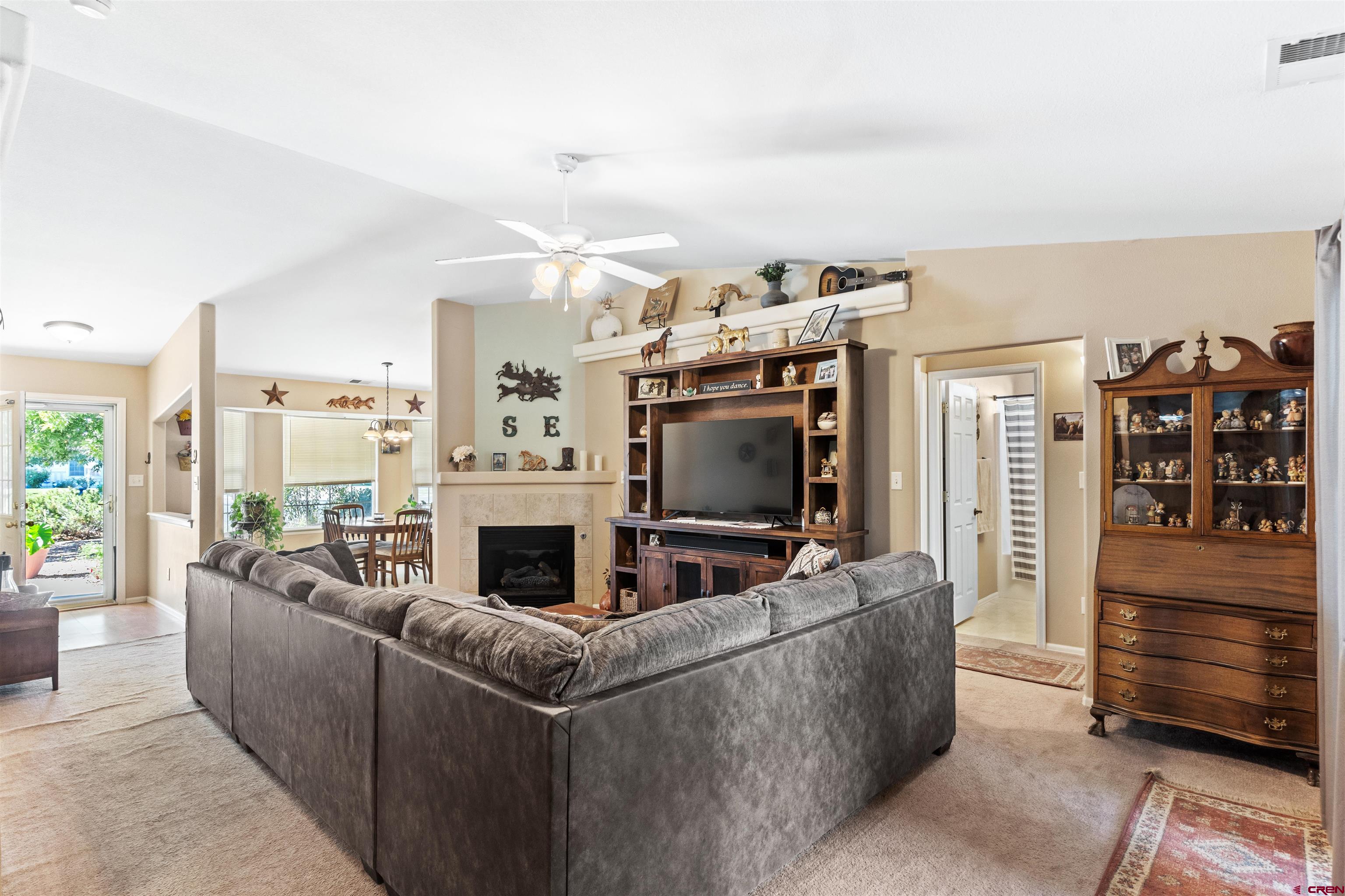 505 20th Street Delta, CO 81416 - Photo 9 of 22 a living room with furniture a flat screen tv and a fireplace