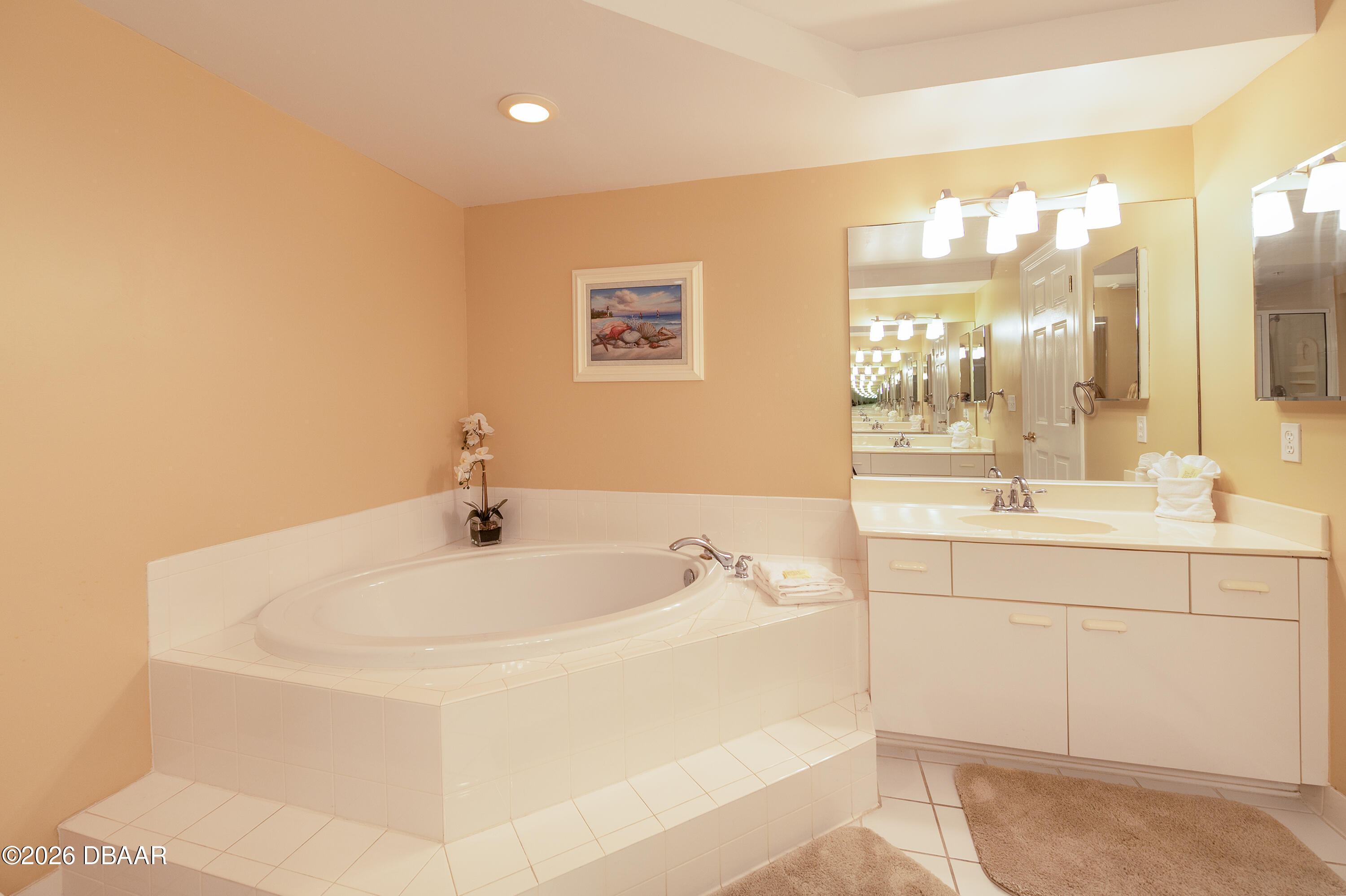 4575 South Atlantic Avenue, Unit 6701 Ponce Inlet, FL 32127 - Photo 20 of 35 a bathroom with a tub sink and mirror