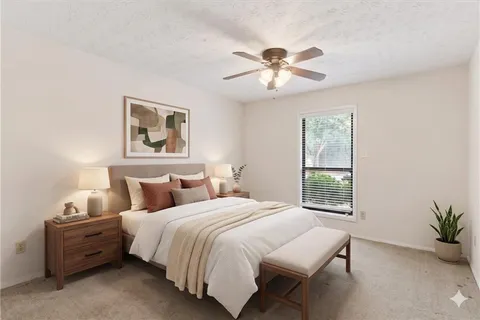 a bedroom with a large bed and a window