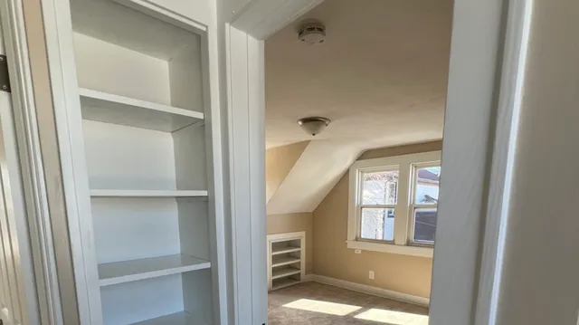 a view of cabinet and a windows and entryway