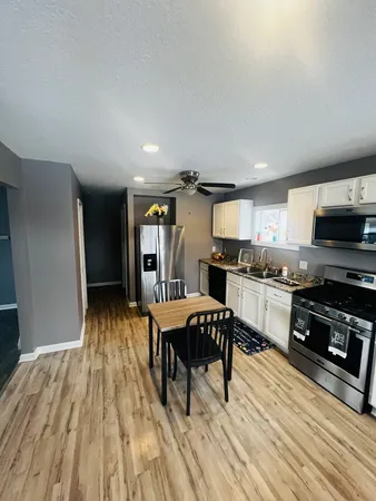 a kitchen with granite countertop stainless steel appliances and wooden cabinets