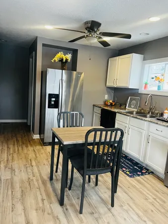 a kitchen with a table chairs and a refrigerator