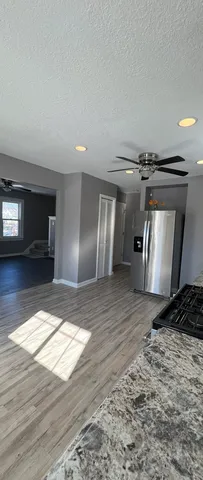 a view of a refrigerator in kitchen and wooden floor