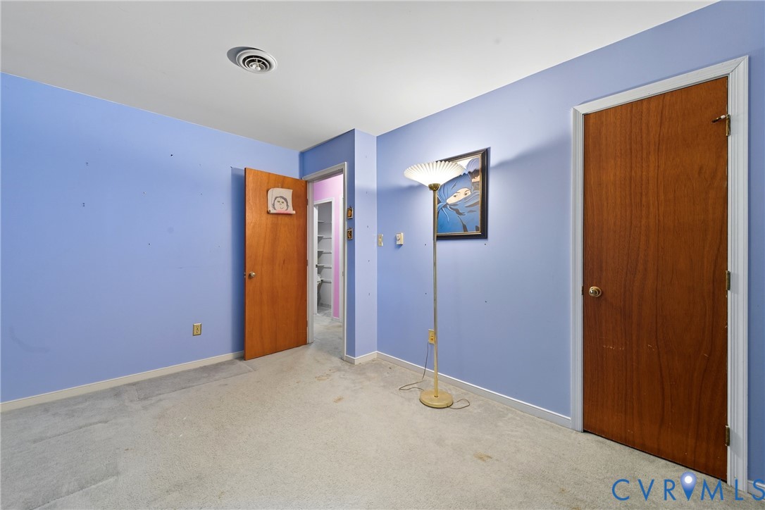 5606 Retriever Road Richmond, VA 23237 - Photo 20 of 27 a view of an empty room with closet and wooden door