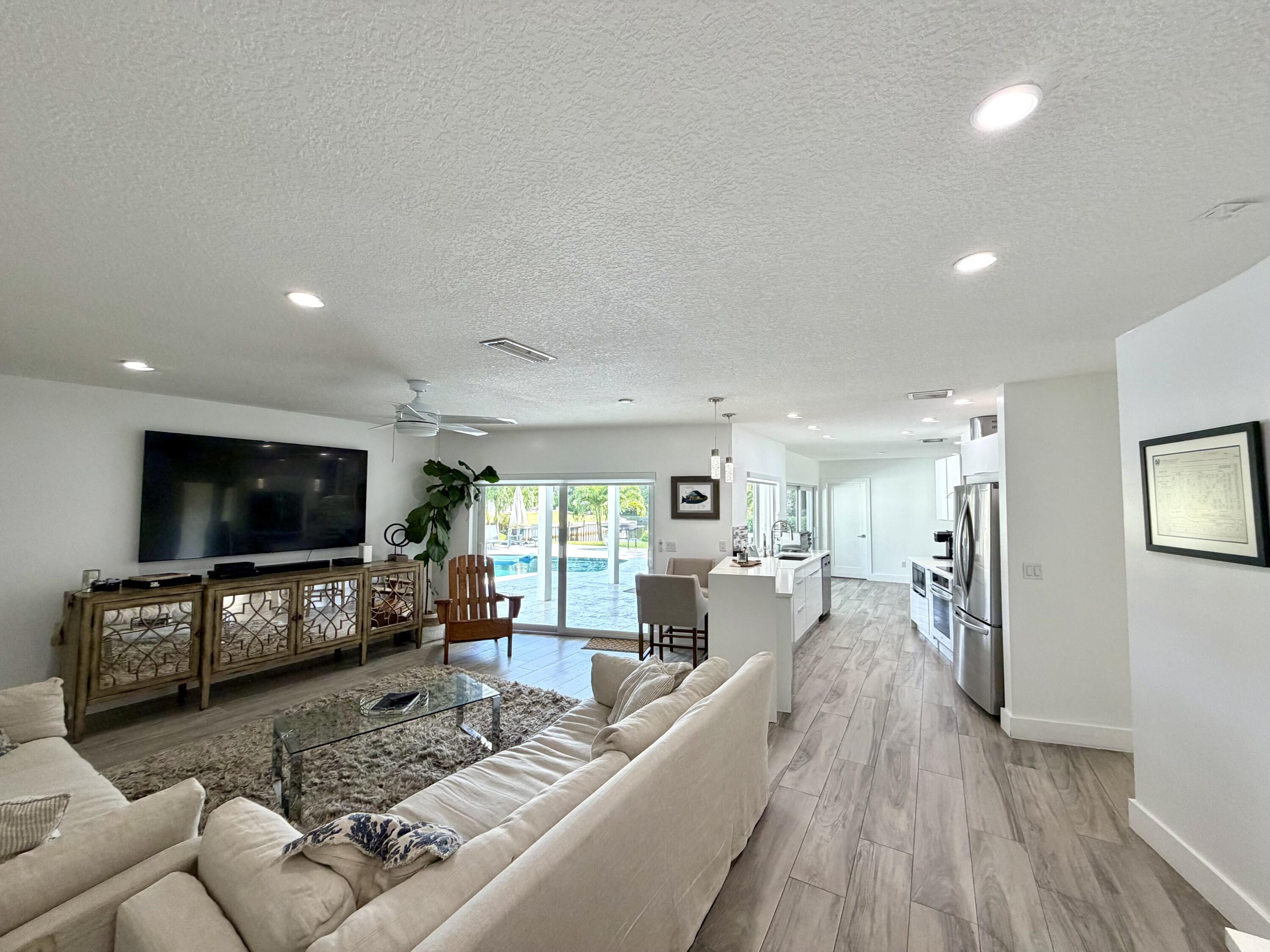 100 Southwest 11th Avenue Boca Raton, FL 33486 - Photo 1 of 34 a living room with furniture and a flat screen tv