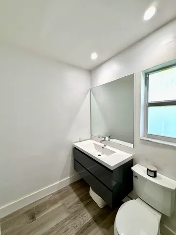 a bathroom with a sink toilet and mirror