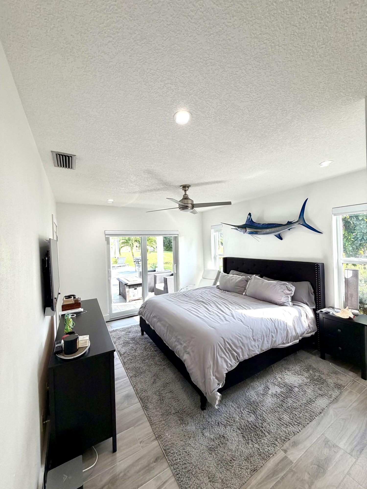 100 Southwest 11th Avenue Boca Raton, FL 33486 - Photo 17 of 34 a bedroom with a bed and window