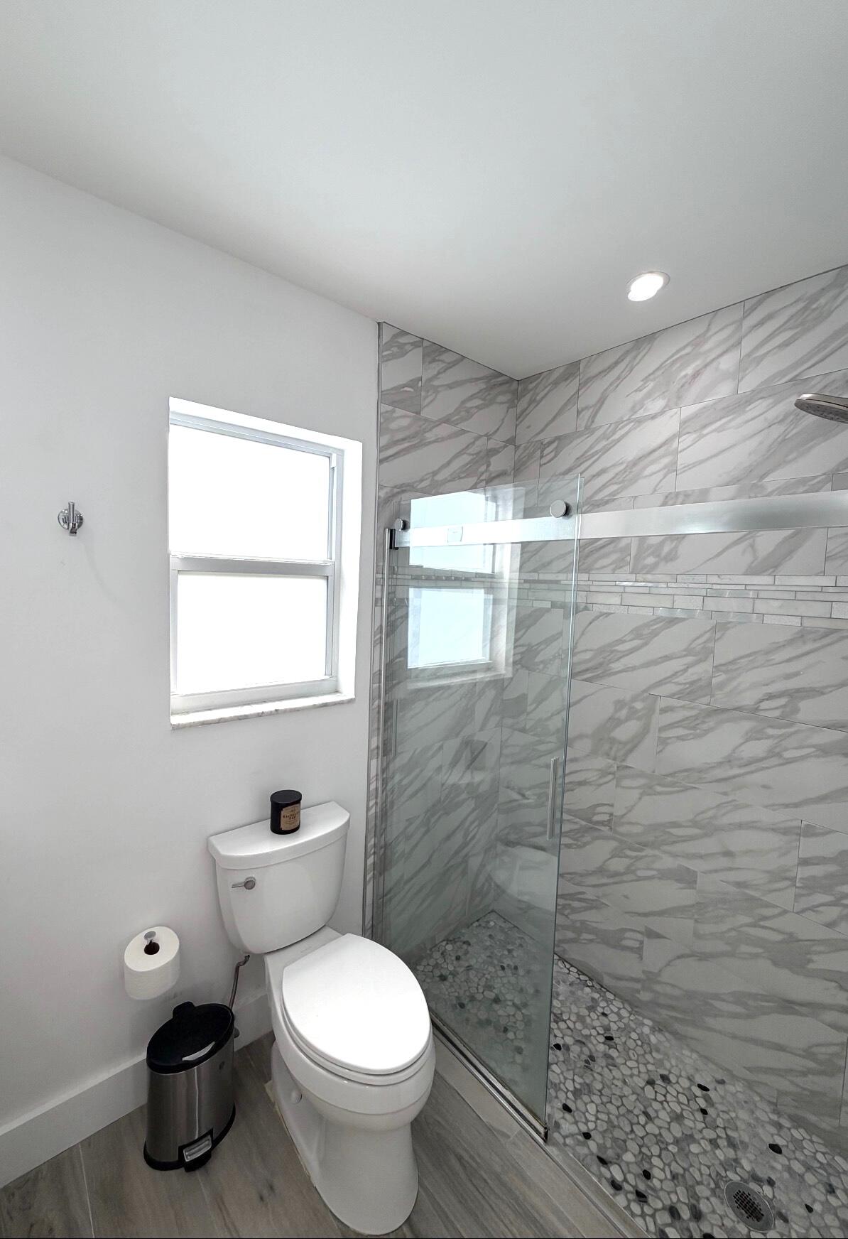 100 Southwest 11th Avenue Boca Raton, FL 33486 - Photo 21 of 34 a bathroom with a toilet and a shower