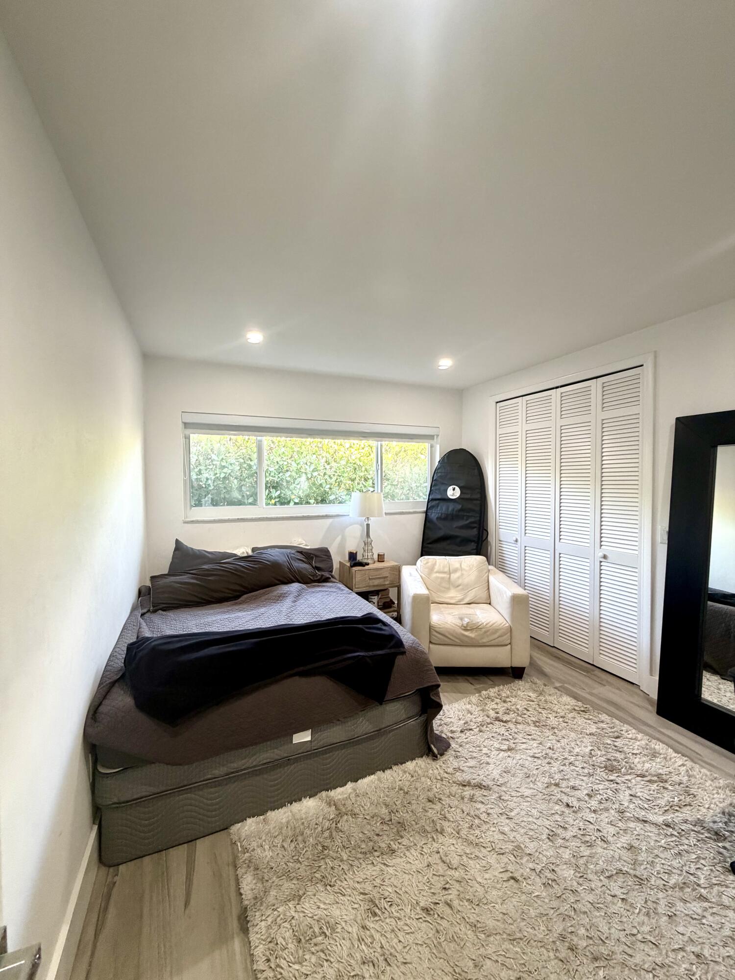 100 Southwest 11th Avenue Boca Raton, FL 33486 - Photo 24 of 34 a bedroom with a bed and a large window