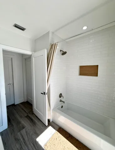 a bathroom with a bathtub and shower