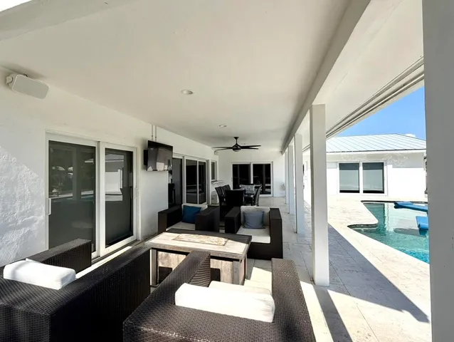 a living room with furniture rug and outdoor view