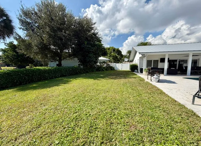 a view of a house with garden and patio