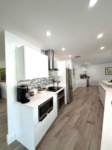 a kitchen with a stove and a refrigerator