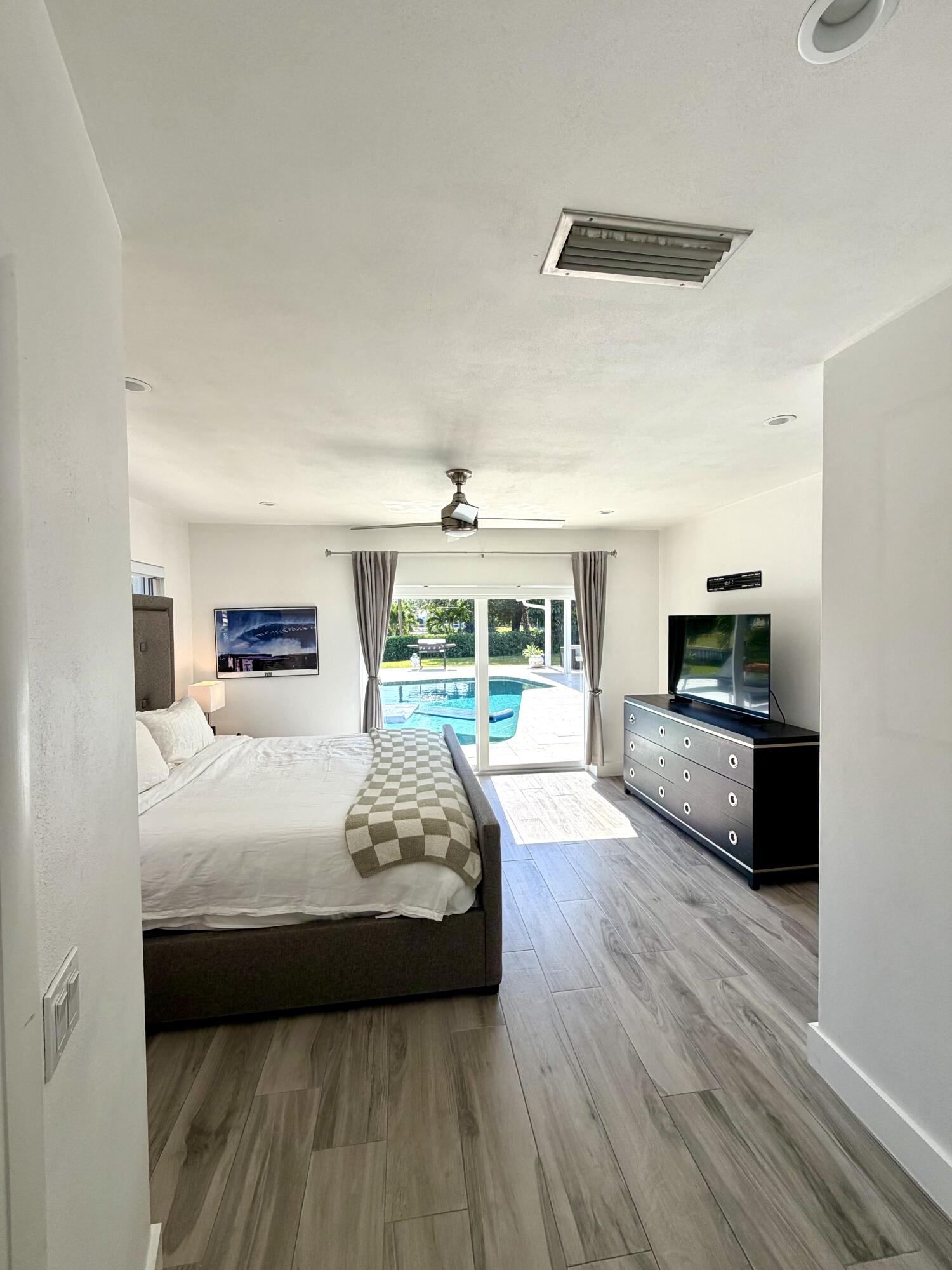 100 Southwest 11th Avenue Boca Raton, FL 33486 - Photo 8 of 34 a bedroom with a bed a couch and a large window