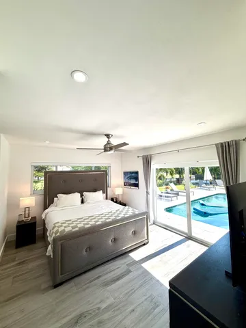 a bedroom with a large bed and a large window