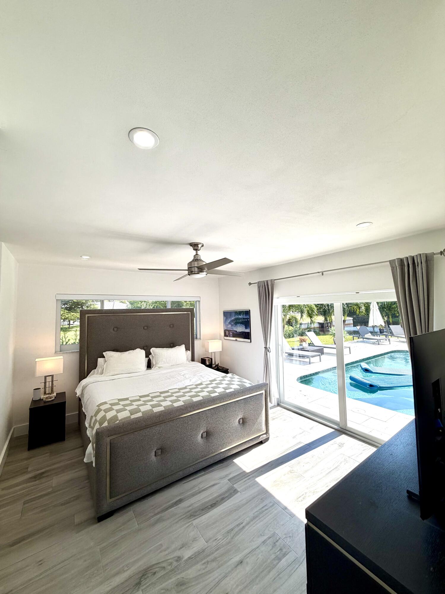 100 Southwest 11th Avenue Boca Raton, FL 33486 - Photo 9 of 34 a bedroom with a large bed and a large window