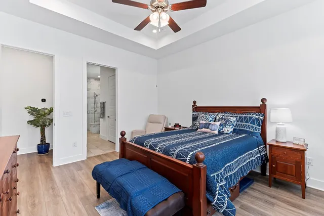 a bed room with a bed and a chandelier