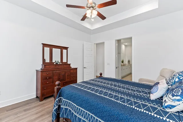 a bedroom with a bed and a dresser in it