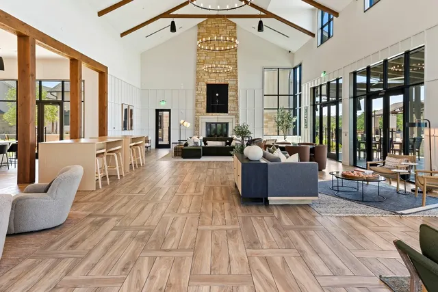 a living room with furniture and large windows