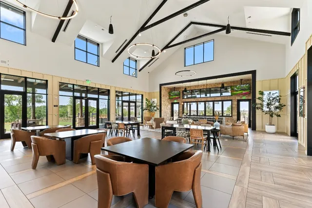 a kitchen with a table chairs and white appliances