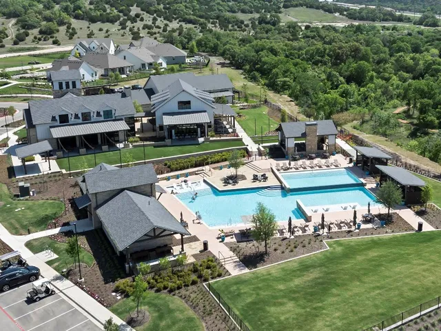 an aerial view of a house with garden space and street view