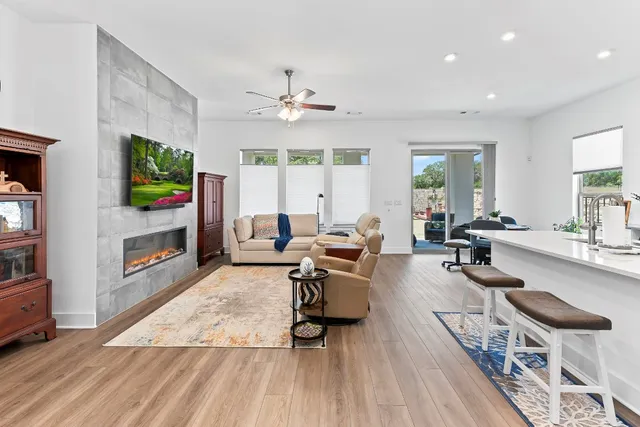 a living room with fireplace furniture and a flat screen tv