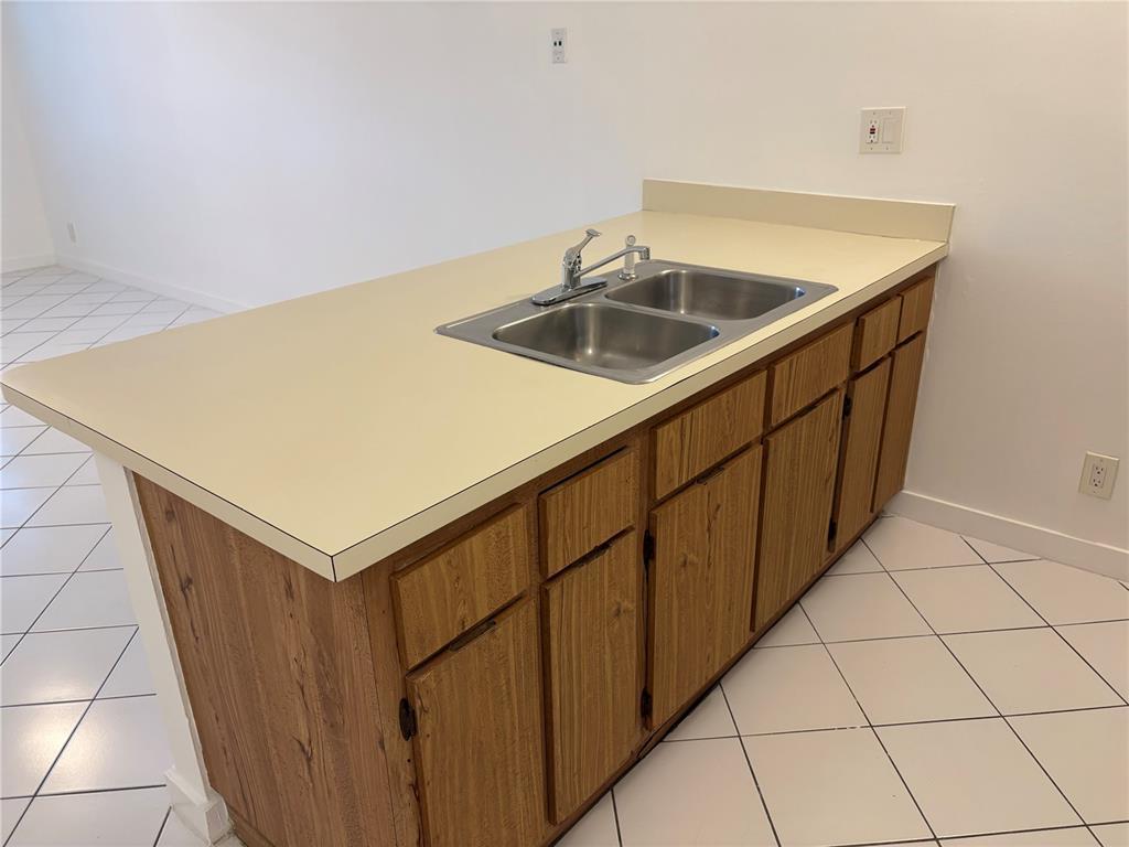 2401 Riverside Drive, Unit 314B Coral Springs, FL 33065 - Photo 6 of 11 a kitchen with a sink and cabinets