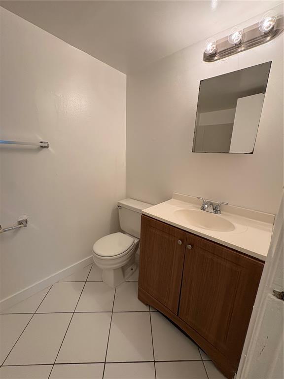 2401 Riverside Drive, Unit 314B Coral Springs, FL 33065 - Photo 9 of 11 a bathroom with a sink a toilet and a mirror