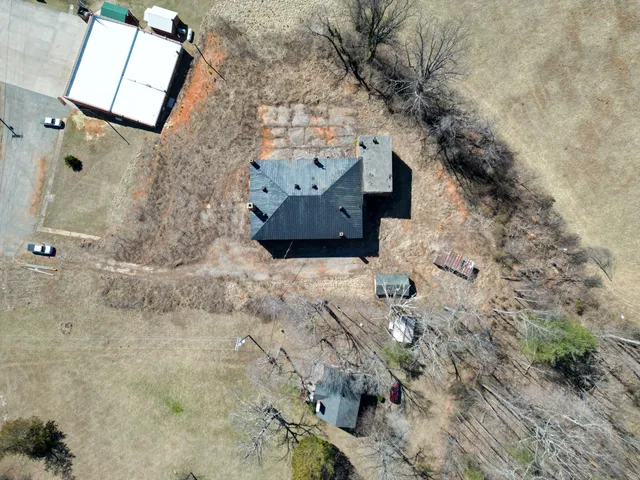 an aerial view of a house with a yard