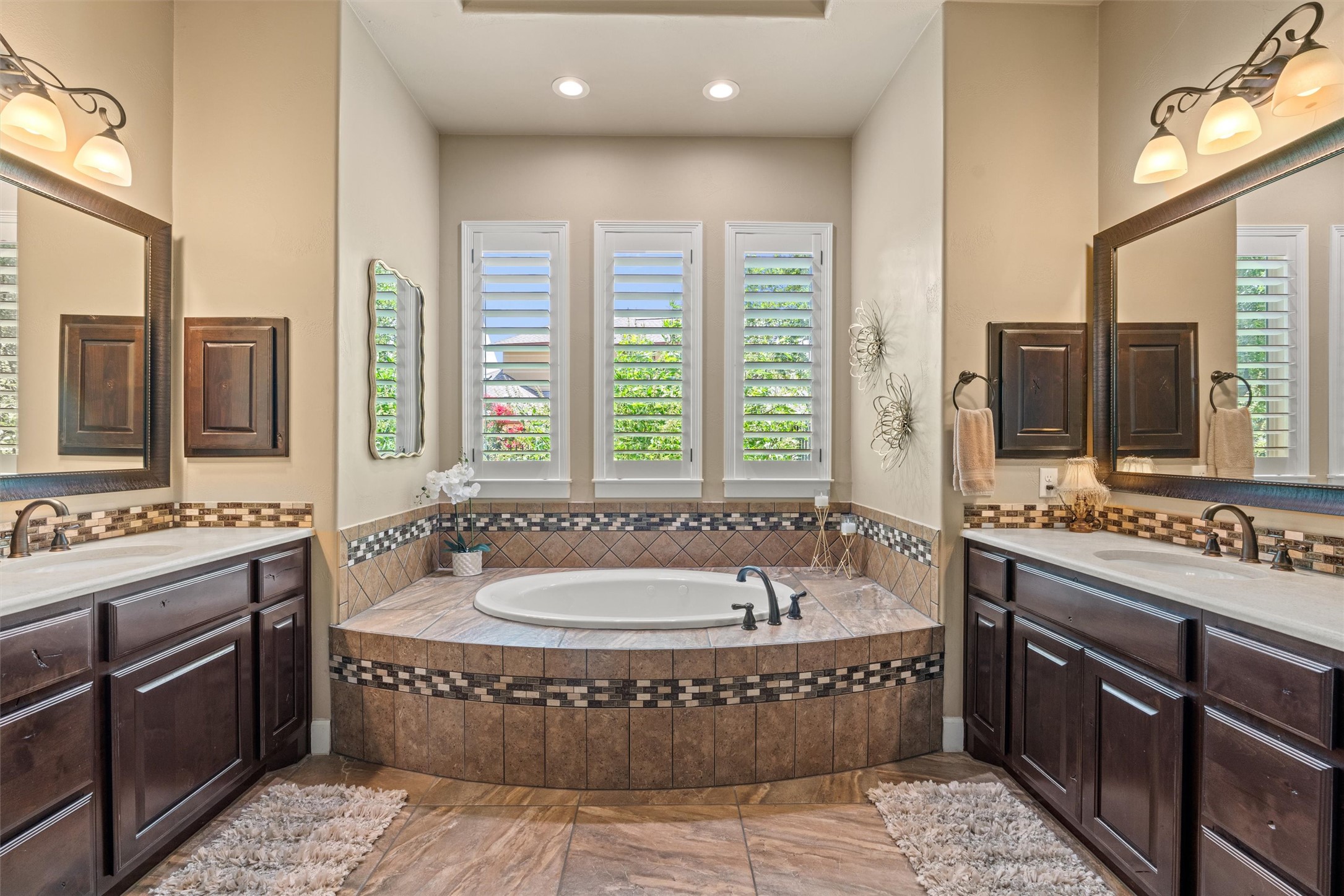 104 Adobe Cove Georgetown, TX 78633 - Photo 14 of 40 Luxurious primary bathroom featuring a large soaking tub and dual vanities, perfect for unwinding.